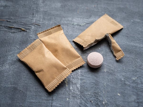 Plantish Future Tablet Refills All Purpose Cleaning Tablets - 3 packs of cleaning tablets in kraft paper packaging with one opened and a pink tablet taken out