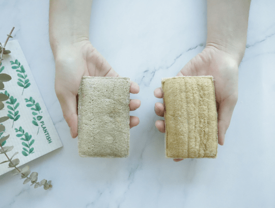 Plantish Future Home & Kitchen Eco Sponge held with hands beside Swedish Sponge Cloth